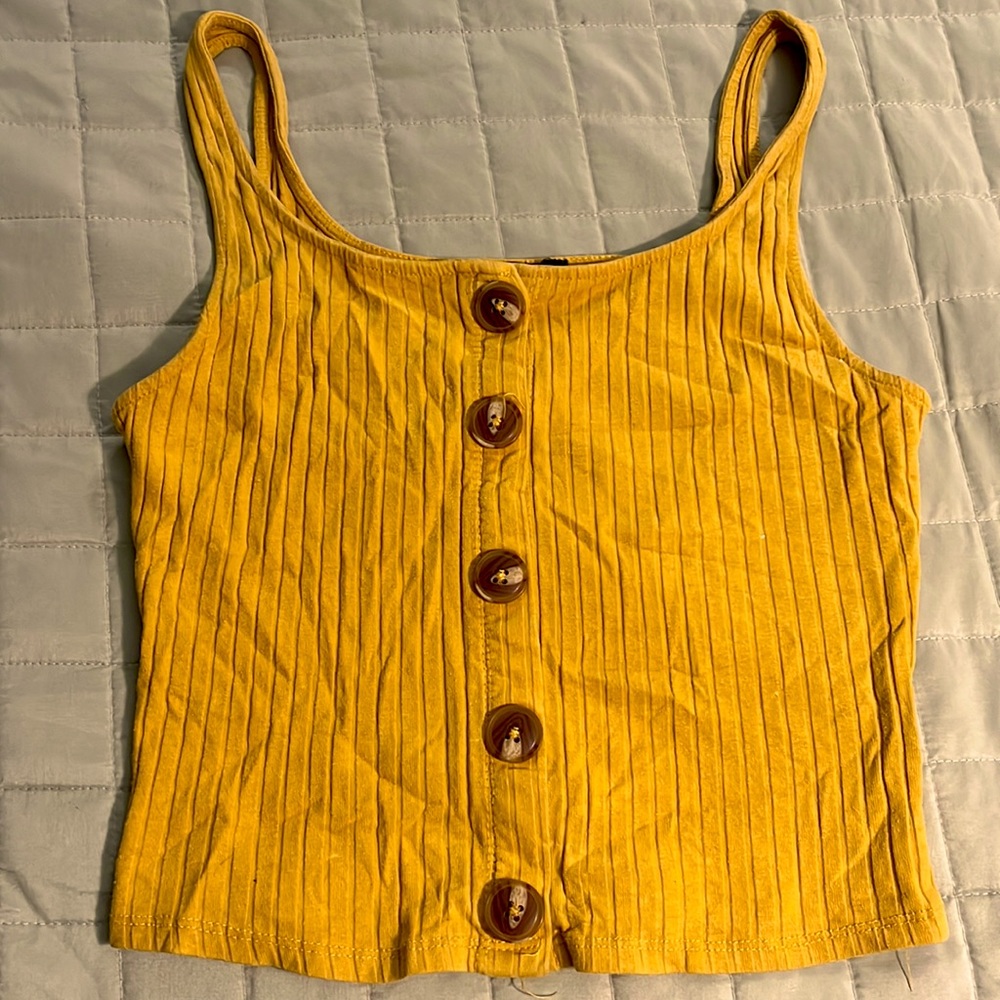 It’s a orange tank top small. It’s also a little cropped with buttons.